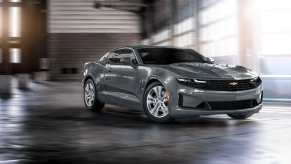 2022 Chevy Camaro muscle car in gray driving through a parking garage hangar