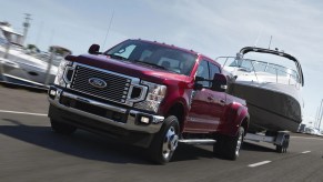 A red 2022 Ford F-250 towing a boat.