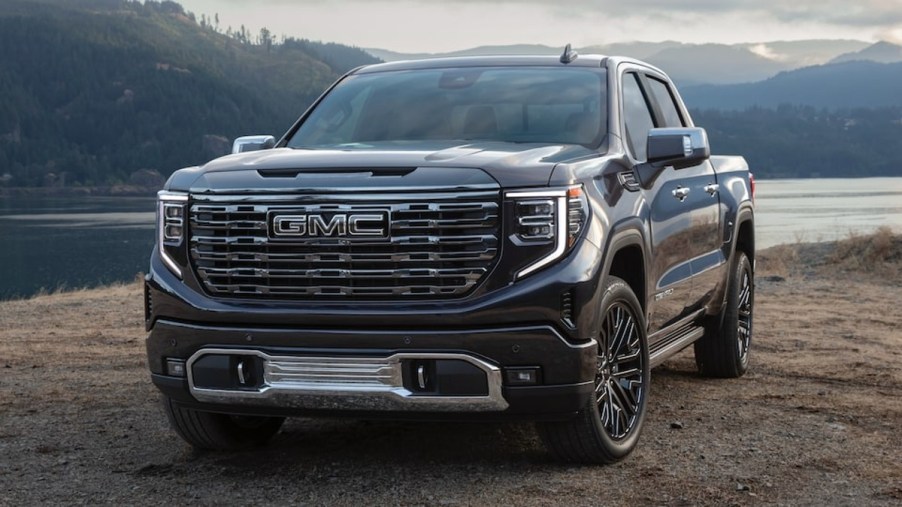 Black 2022 GMC Sierra 1500 Denali Ultimate on a dirt trail