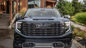 2022 GMC Sierra Denali Ultimate full-size pickup truck parked outside of a luxury forest dwelling