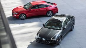 An overhead shot of 2022 Hyundai Sonata models in red and black parked on a slate plaza