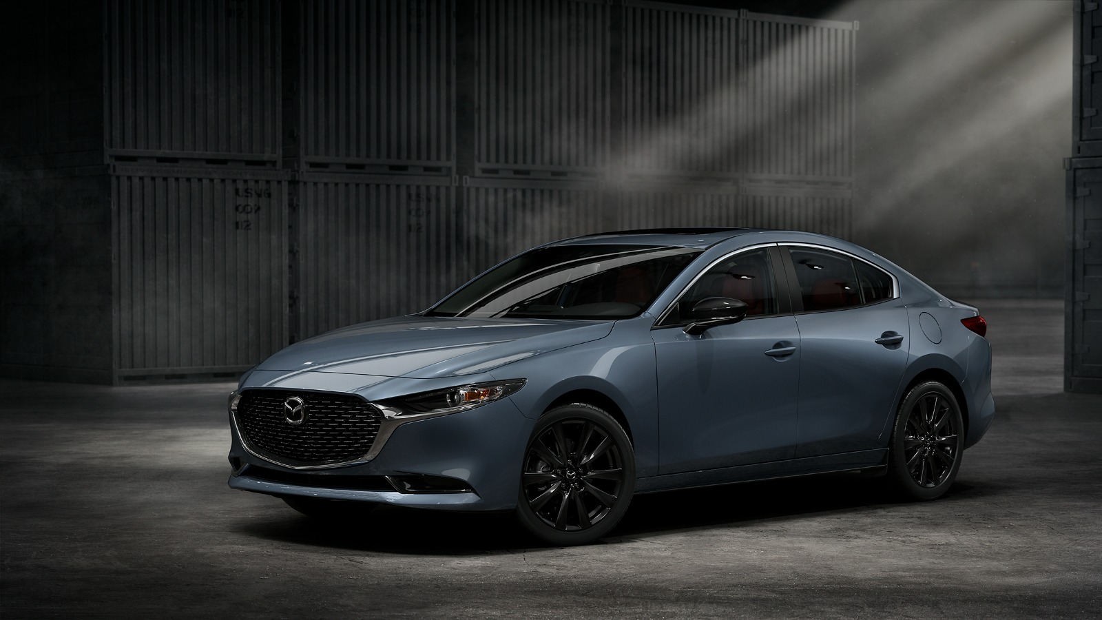 Angled side view of 2022 Mazda3 2.5 Sedan in grey, one of the cheapest all-wheel drive cars