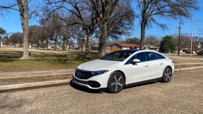 The front 3/4 view of a white 2022 Mercedes-Benz EQS 450+ Premium on a street