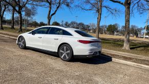 The side 3/4 view of a white 2022 Mercedes-Benz EQS 450+ on a street