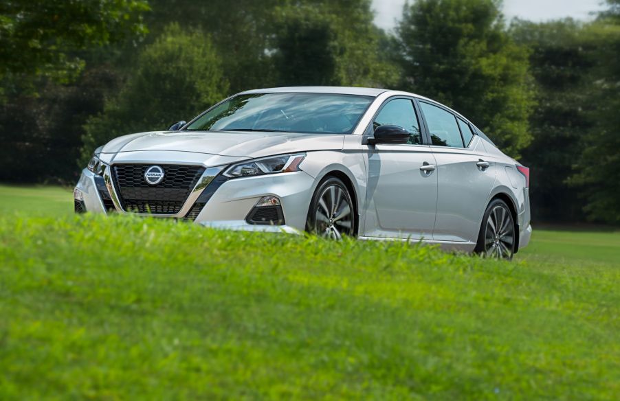 2022 Nissan Altima midsize sedan with a silver paint color option parked in a field of grass