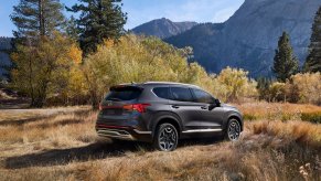 A gray 2022 Hyundai Santa Fe Hybrid parked by mountains.