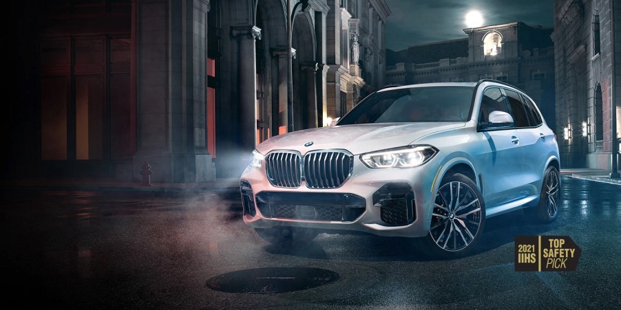 A white 2022 BMW X5 against a city background.