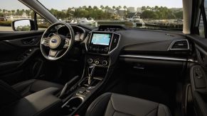 Interior view of the 2022 Subaru Impreza in black; black cloth interior, 6.5-inch infotainment screen, and automatic transmission