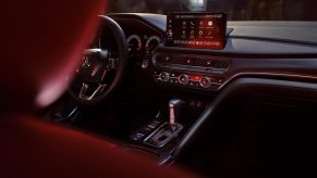 The black dashboard and red front seats of a 2023 Acura Integra with a CVT