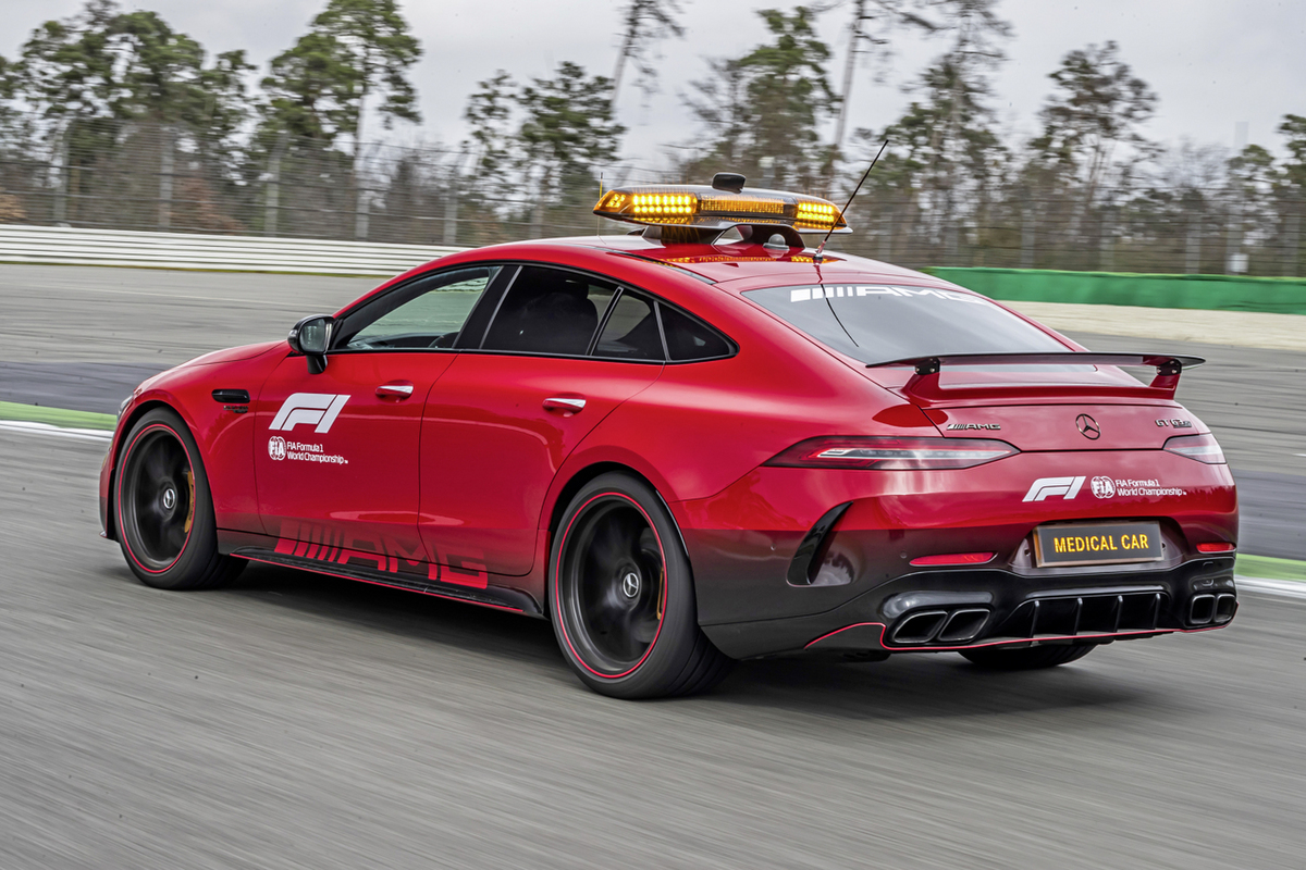 A 3/4 rear view of the red Mercedes-AMG GT 63 S 4Matic+ F1 Medical Car driving on a race track.