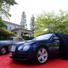 1964 Bentley S3 Saloon parked on a red carpet next to the unveiling of the new Bentley Flying Spur V8 in Japan