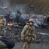 Burned Area With Soldiers Looking On during Russian Invasion of Ukraine