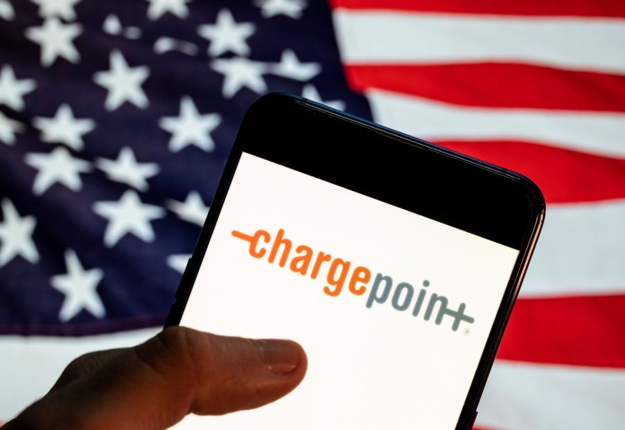 The ChargePoint EV app on a smartphone with an American flag background