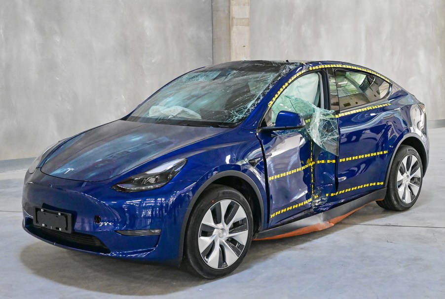 Blue Tesla Model 3 after crash test impact on driver's side