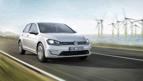 Volkswagne e-Golf driving near wind farm