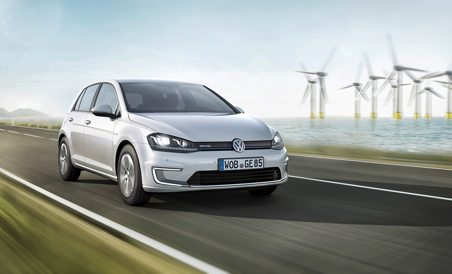 Volkswagne e-Golf driving near wind farm