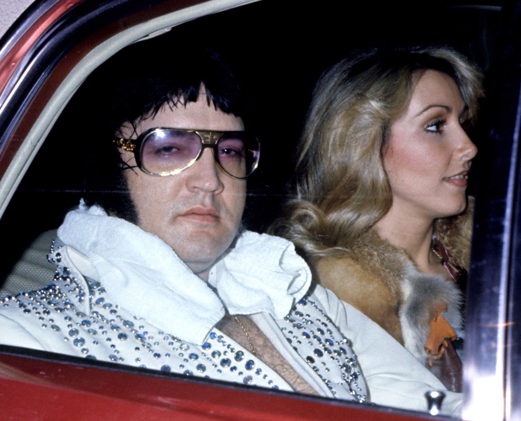 Elvis Presley with girlfriend Linda Thompson riding in a car after a concert in March 1976