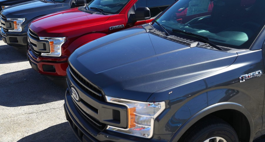 Ford F-150 pickup trucks on a lot.