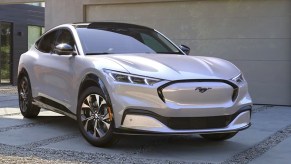 A white Ford Mustang Mach-E electric SUV is parked.