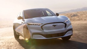 A white Ford Mustang Mach-E electric SUV.