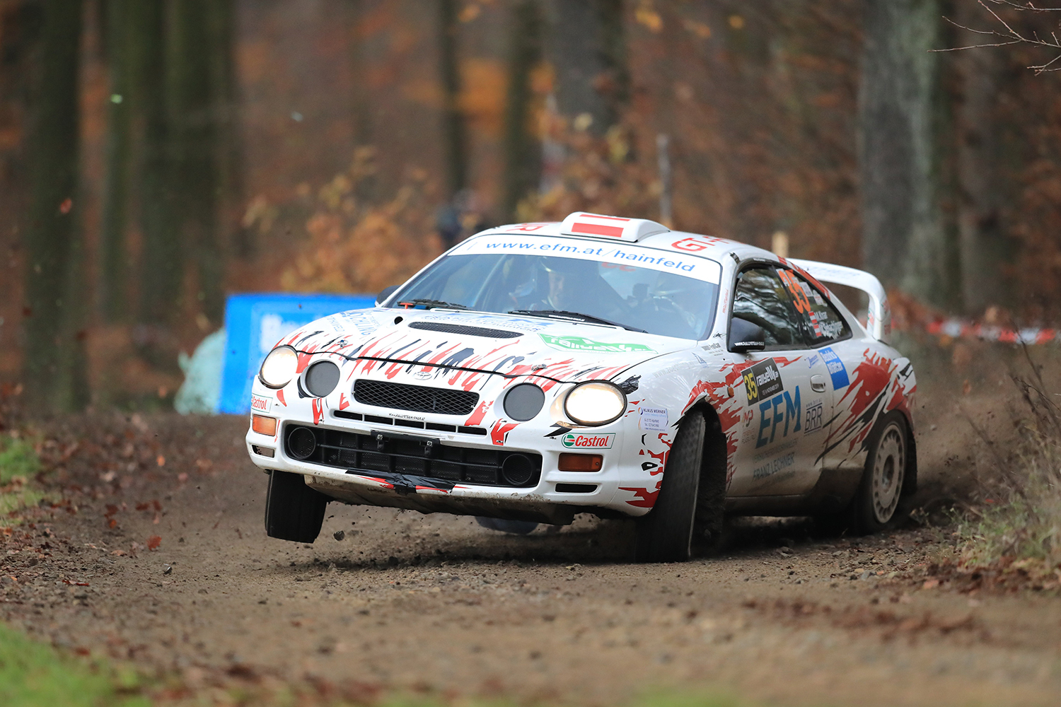 Toyota Celica Rally car sliding sideways around a corner in the dirt