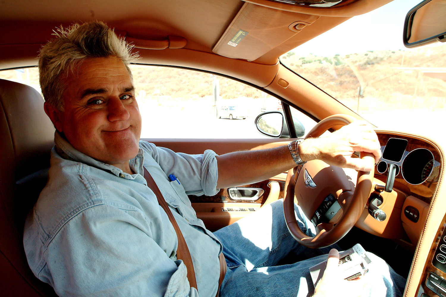 Closeup of Jay Leno smiling while driving a 2004 Bentley S2 Coupe