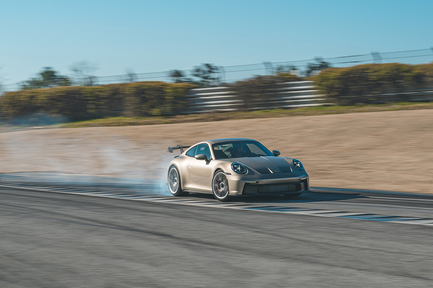 Leh Keen driving his 2022 Porsche 911 GT3 in custom Gold Bronze Metallic paint on race track