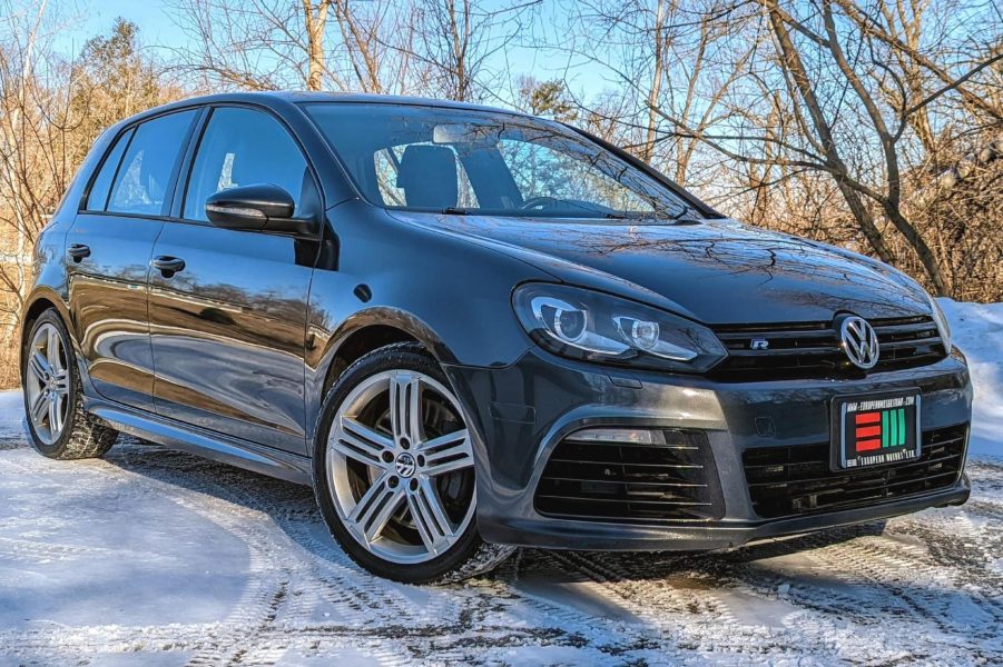 A gray modified 2013 Volkswagen Golf R parked on the snow