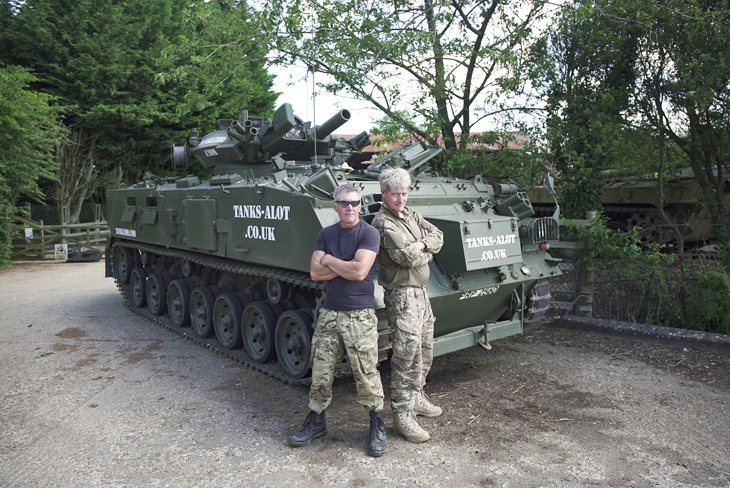 Owners of Tanks-A-Lot and the tank limo standing beside it 