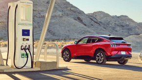 Red 2022 Ford Mustang Mach-E parked near a charging stating, highlighting EV battery recycling