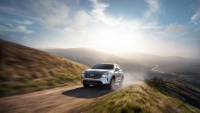 Shimmering Silver 2022 Hyundai Santa Fe PHEV driving up a hill