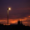 a street light still lit as the sun comes up