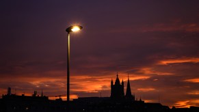 a street light still lit as the sun comes up