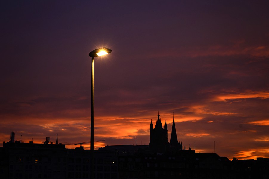 a street light still lit as the sun comes up