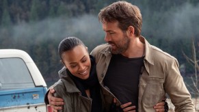 Ryan Reynolds hugs Zoe Saldana in front of a GMC Jimmy SUV during The Adam Project film.