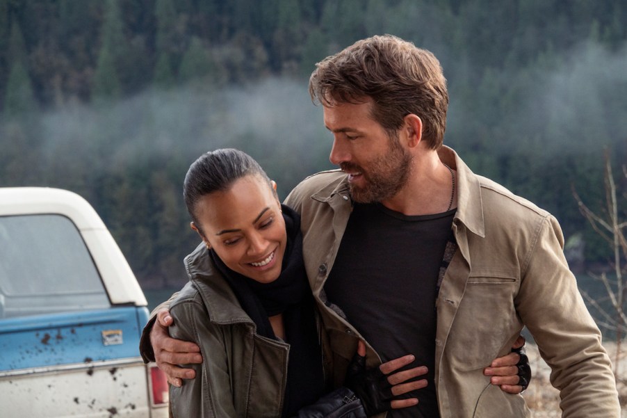 Ryan Reynolds hugs Zoe Saldana in front of a GMC Jimmy SUV during The Adam Project film.