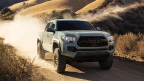 A green 2022 Toyota Tacoma is driving off-road.