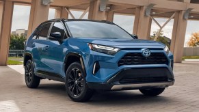 A blue 2022 Toyota RAV4 Hybrid small SUV is parked.