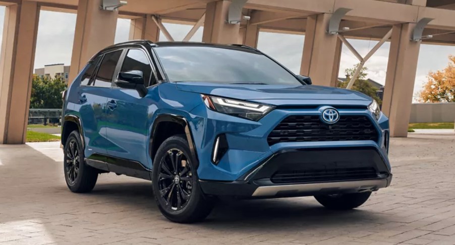 A blue 2022 Toyota RAV4 Hybrid small SUV is parked.