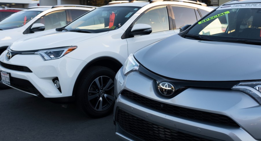 Toyota RAV4 SUVs on a car lot.