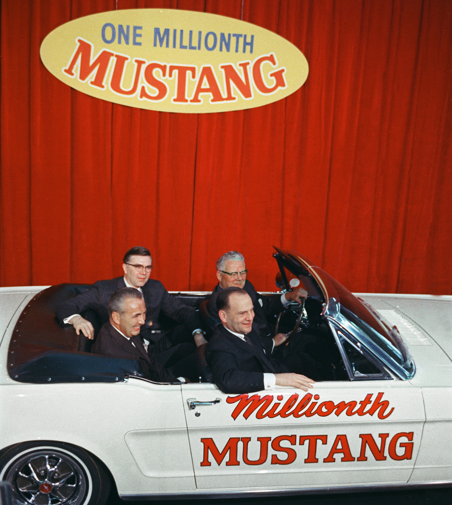 Airline Captain Stanley Tucker with Lee Iacocca and Ford executives in the one-millionth Ford Mustang