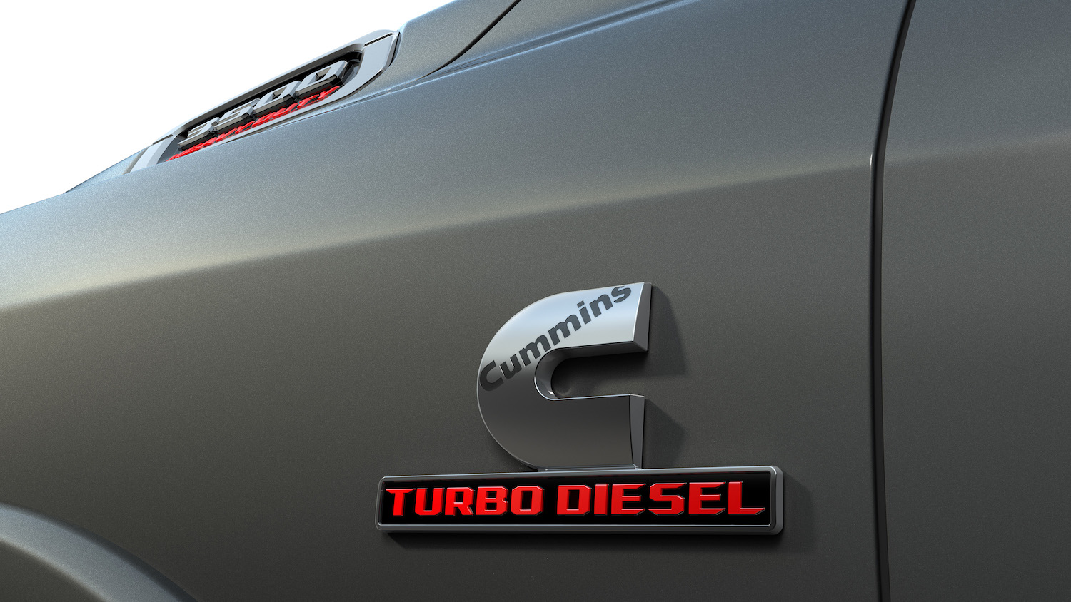 Detail shot of a Cummins Turbo Diesel badge on the Fender of a Ram 3500 truck.