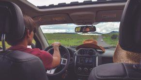 A driver drives their car around with the sunroof open