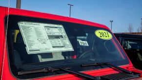 2021 Jeep Gladiator sticker price and MSRP on a car dealership lot in Lansing, Kansas