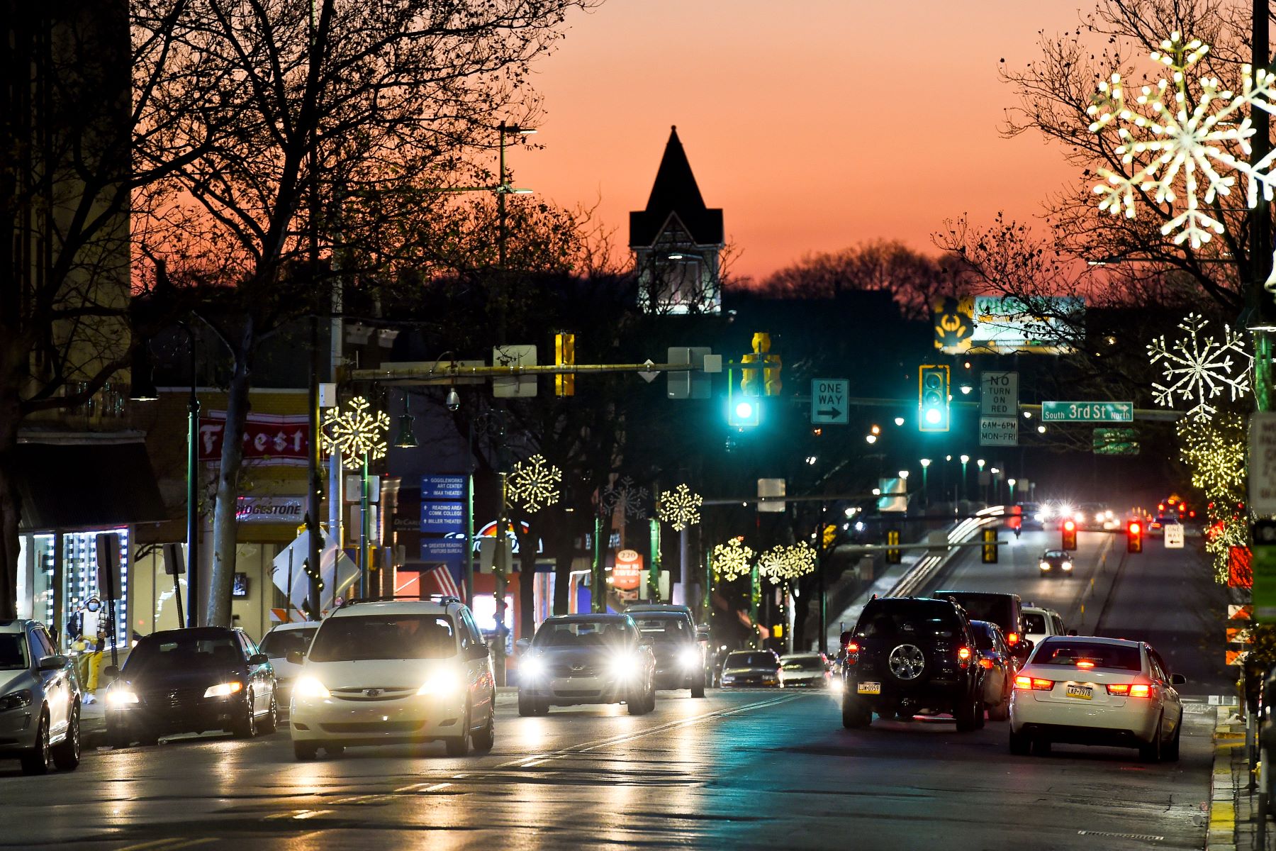 Car using their headlights as the sun sets at night in Reading, Pennsylvania