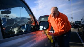 A man cleans his car.