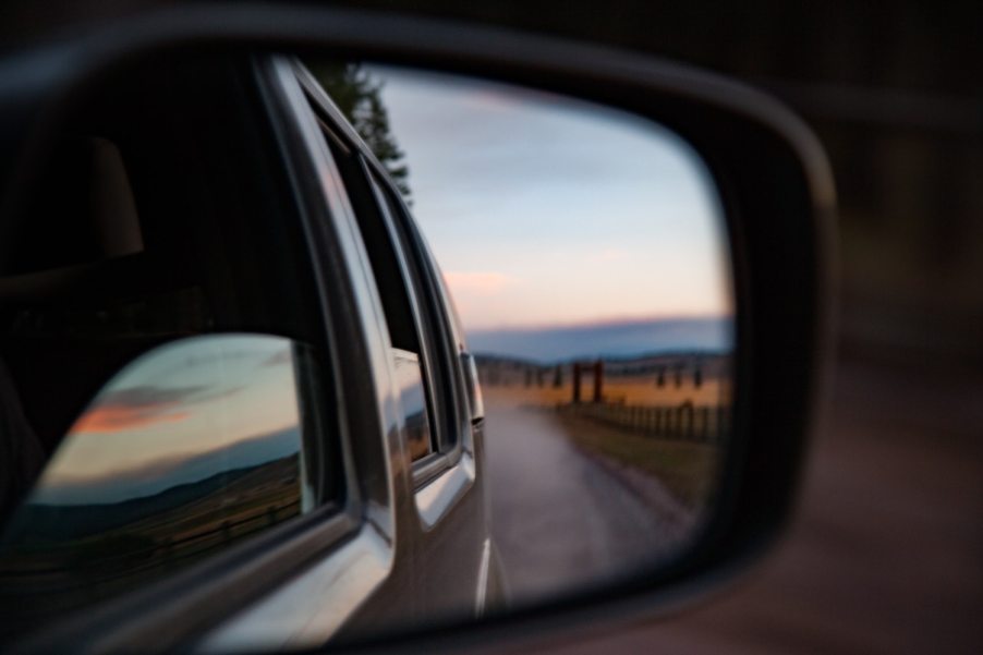 A reflection of car windows in the side mirror