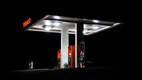 The silhouette of an illuminated gas station canopy at night with off road diesel for sale.