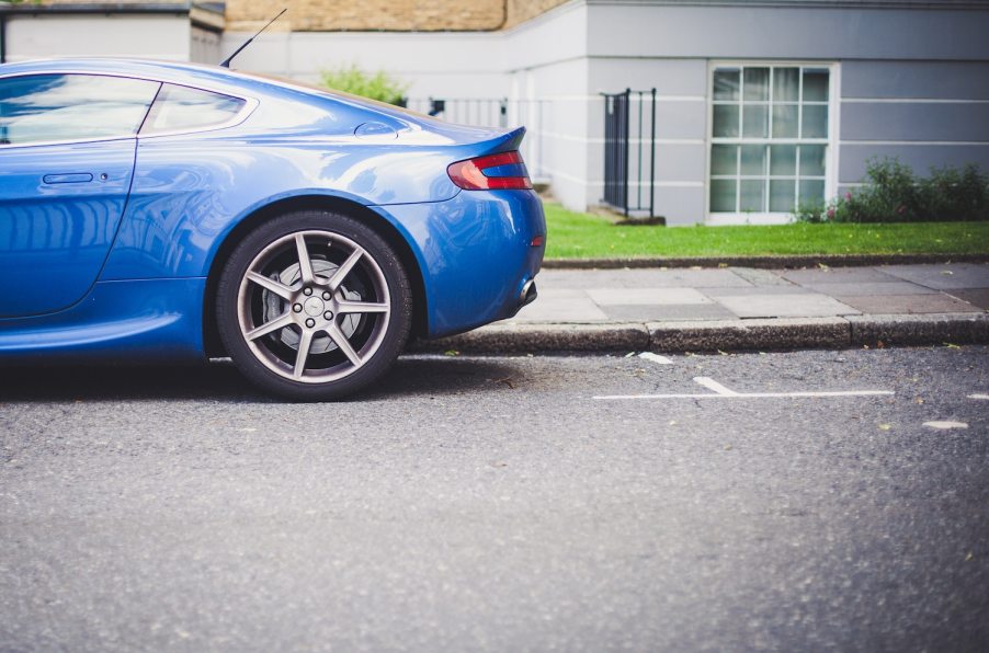 a blue car sits in front of the empty parking spot