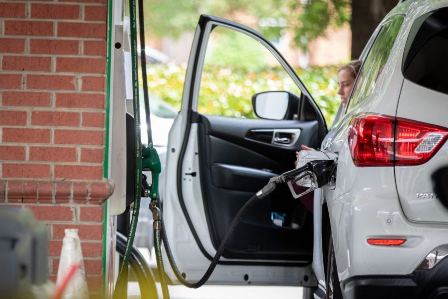 A white SUV pumping gas on their own unlike the poor folks in Jersey who have it have their gas pumped for them.